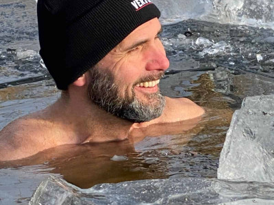 Man practicing cold water immersion during Wim Hof Ice & Breath Workshop.